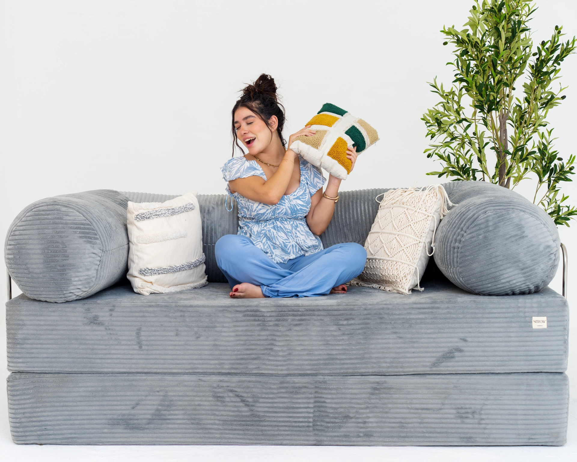 A person relaxing on a comfortable brown sofa.
